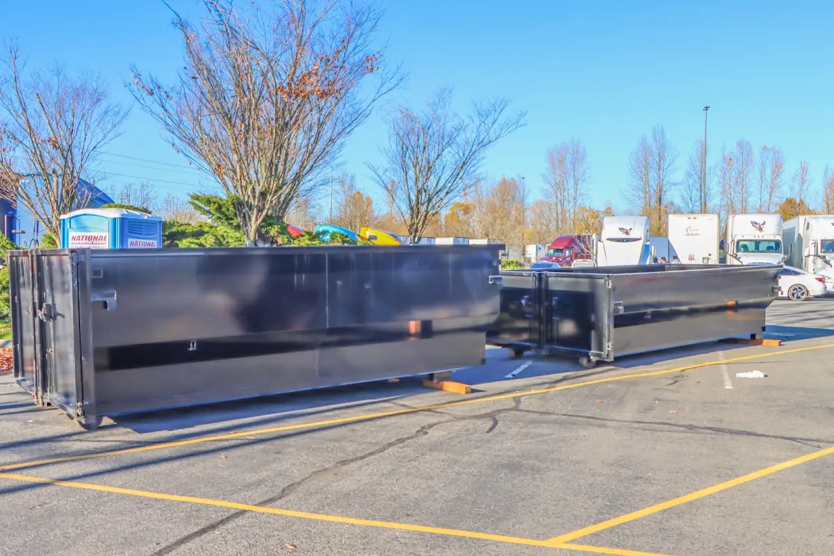 Professional dumpster rental service with roll-off container on residential driveway in Orange Park